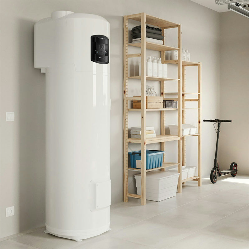 A tall white cylindrical water heater or storage tank with a black control panel, shown in a clean indoor room next to a wooden shelving unit and a scooter.
