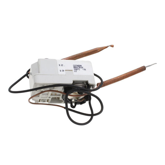 A white plastic electrical component with attached black wires and two copper-colored probes, photographed on a plain white background.