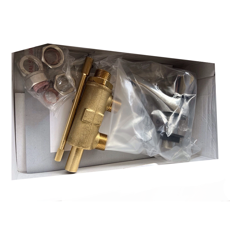 A brass water tap assembly kit inside its open cardboard box, containing a brass filter cartridge, a brass wrench, mounting nuts, washers, and a silver-colored metal component sealed in a clear plastic bag.